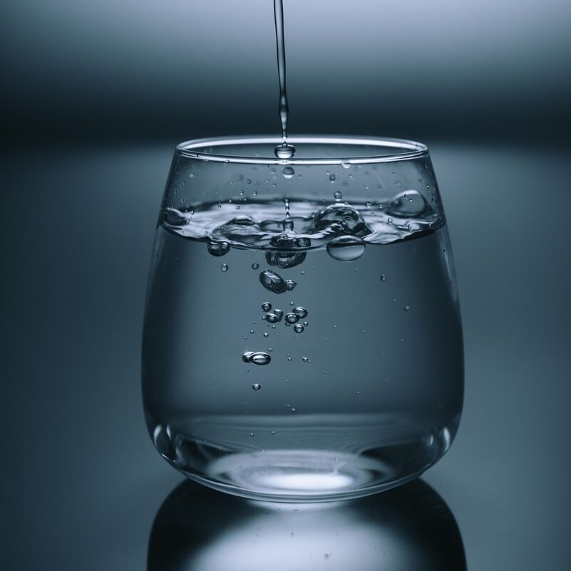 clear drinking glass on gray surface